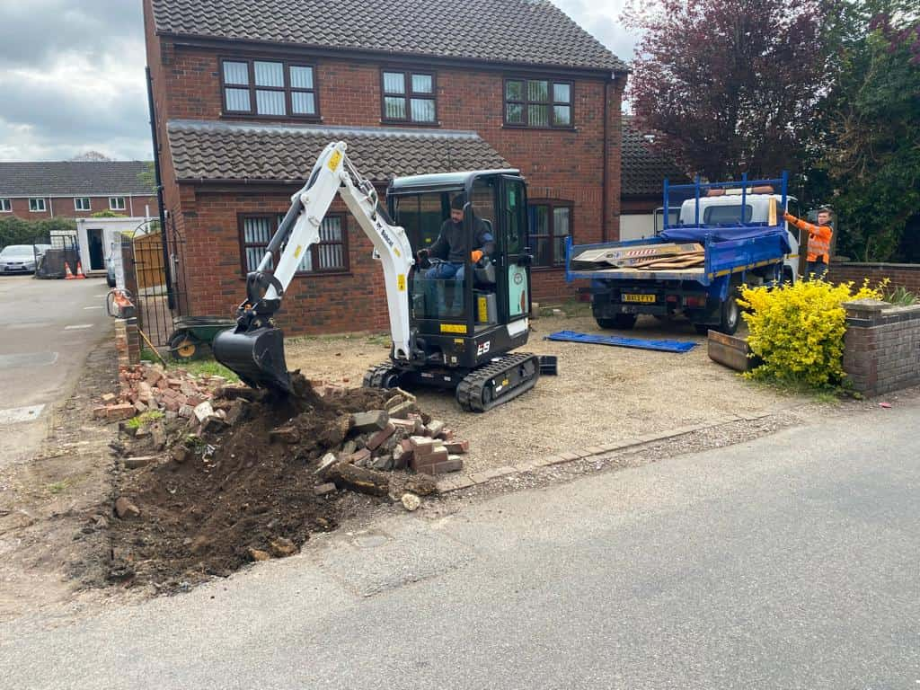 This is a photo of an operative of NS Driveways Billingshurst Digging out for a new tarmac driveway